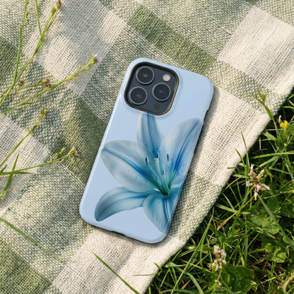 Blue floral iphone case sitting on a fabric surface with a grass background