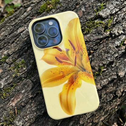 iPhone 15 pro case with a yellow flower design sitting on a tree trunk