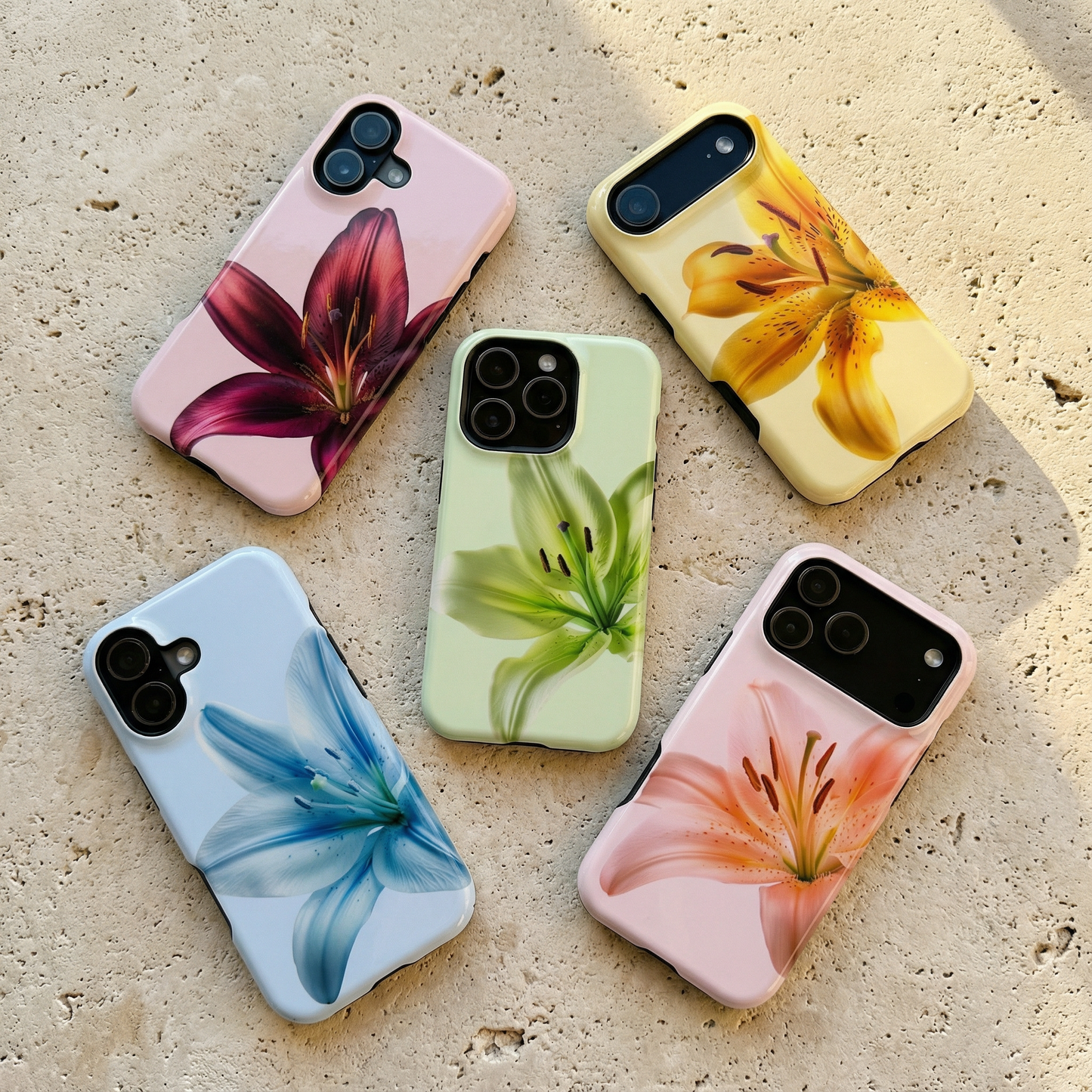 Five designer floral iphone cases on a limestone textured surface